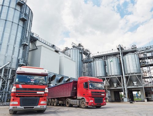 Agricultural Silo - Building Exterior, Storage and drying of grains, wheat, corn, soy, sunflower and two trucks waiting